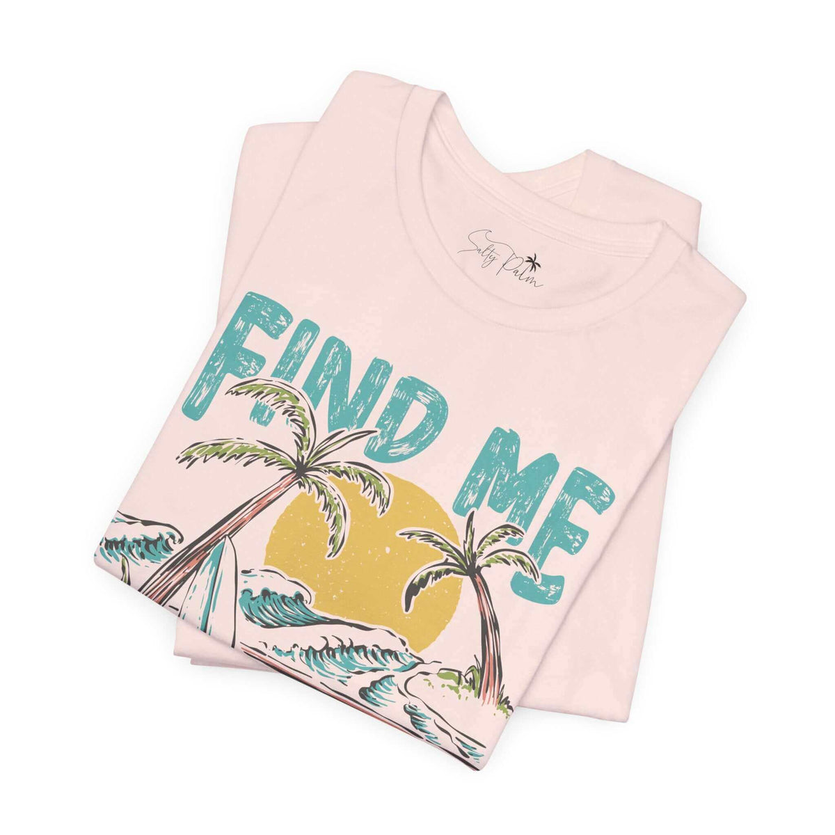 Soft pink graphic tee with tropical palm tree design and text "Find Me" on organic cotton fabric. Perfect for beach lovers.