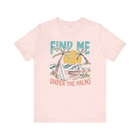 Soft pink graphic tee with tropical palm design, "Find Me Under The Palms" text, made of organic cotton, perfect for beach lovers.