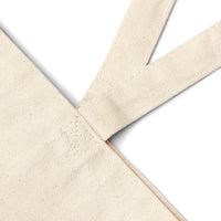 Close-up of twin carry handles on the Pray for Surf Canvas Tote Bag, made from 100% organic cotton.