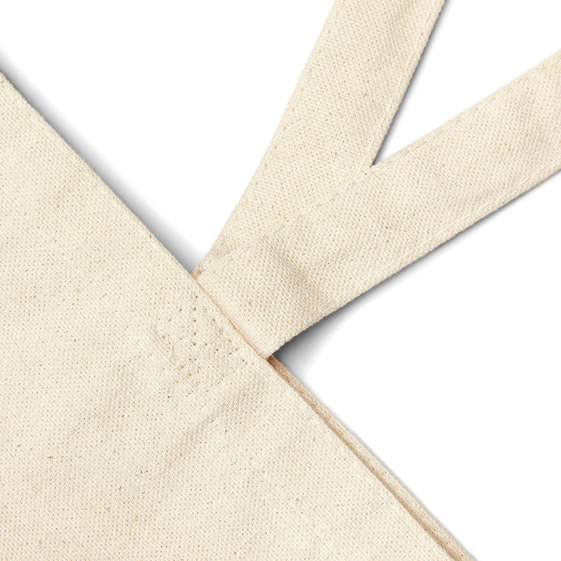 Close-up of twin carry handles on the Pray for Surf Canvas Tote Bag, made from 100% organic cotton.